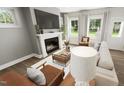Inviting living room features a fireplace, large windows, and comfortable seating, perfect for relaxation at 309 Beacon Dr, Pittsboro, NC 27312