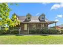 Charming two-story brick home with a large wrap-around porch and dormer windows at 319 Knox Rd, Gibsonville, NC 27249