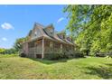 Charming two-story brick home with a large wrap-around porch and dormer windows at 319 Knox Rd, Gibsonville, NC 27249