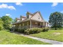 Charming two-story brick home with a large wrap-around porch and dormer windows at 319 Knox Rd, Gibsonville, NC 27249