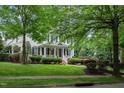 Charming two-story home with black shutters, front porch and professionally landscaped yard at 3325 Falls River Ave, Raleigh, NC 27614