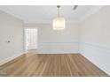 Elegant dining room with classic wainscoting and a stylish chandelier, perfect for entertaining at 340 Allister Dr # 301, Raleigh, NC 27609