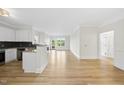 Bright and airy living room featuring hardwood floors and an open layout with large windows at 340 Allister Dr # 301, Raleigh, NC 27609