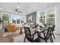 Bright living room with dining table, hardwood floors, and a large window with natural light at 3908 Lost Fawn Ct, Raleigh, NC 27612