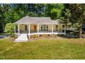 Inviting one-story home featuring a cozy front porch and beautifully landscaped front yard at 4220 Hope Valley Road Rd, Durham, NC 27707