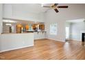 Bright living room with hardwood floors, vaulted ceiling, and open layout to the kitchen at 4220 Hope Valley Road Rd, Durham, NC 27707