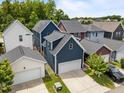 Aerial view of houses with blue siding and white garages in a well-maintained neighborhood with manicured lawns at 450 Granite Mill Blvd, Chapel Hill, NC 27516