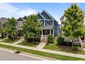 Charming two-story home with blue siding, a red front door, a cozy front porch and landscaped front yard at 450 Granite Mill Blvd, Chapel Hill, NC 27516