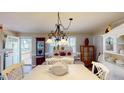 Bright dining room with white table, swan centerpiece, and decorative chandelier at 4509 Stevens Chapel Rd, Smithfield, NC 27577