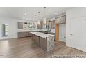 Bright kitchen with a generous island, stainless steel appliances, and convenient access to the outdoors at 56 Mable Court # 20, Lillington, NC 27546