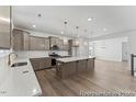Spacious kitchen featuring ample counter space, a large center island, pendant lighting, and modern appliances at 56 Mable Court # 20, Lillington, NC 27546