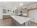 Well-appointed kitchen with an expansive island, stylish pendant lights, and plenty of cabinet storage space at 56 Mable Court # 20, Lillington, NC 27546
