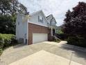 Two-story home boasts a brick and siding exterior with a spacious driveway leading to an attached garage at 5804 Claribel Ct, Raleigh, NC 27612