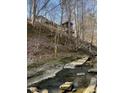 Charming house situated on a sloping hill near a creek, surrounded by trees at 5900 Ebenezer Church Rd, Raleigh, NC 27612