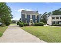 Charming two-story home with a manicured lawn, black shutters, and a bright green front door at 6 W Canterbury Ct, Wendell, NC 27591