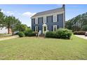 Charming two-story home with a manicured lawn, black shutters, and a bright green front door at 6 W Canterbury Ct, Wendell, NC 27591