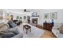 Cozy living room with a brick fireplace, hardwood floors, and lots of natural light at 6 W Canterbury Ct, Wendell, NC 27591