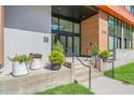 Inviting building entrance with decorative planters and a modern glass door at 615 Daniels St # 215, Raleigh, NC 27605