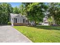 Picture of a charming single-Gathering home with a well-kept lawn and long driveway at 619 E Hatterleigh Ave, Hillsborough, NC 27278