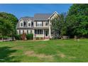 Charming two-story home with a well-manicured lawn and inviting front porch at 8140 Consella Way, Willow Springs, NC 27592