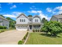 Charming two-story home featuring a manicured lawn, long driveway, and inviting front porch at 85 Clubhouse Dr, Youngsville, NC 27596