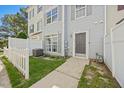 Attractive townhouse featuring a tidy front yard and a freshly painted exterior with a modern front door at 8630 Neuse Landing # 105, Raleigh, NC 27616