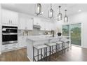 A stunning kitchen features stainless appliances, quartz countertops, subway tile backsplash, and island with seating at 88 Mable Court # 17, Lillington, NC 27546