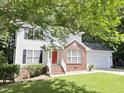 Attractive two-story home with a red brick accent, vinyl siding, a well-manicured lawn, and a two-car garage for convenient parking at 109 Elmview Dr, Cary, NC 27519