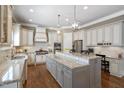 Gourmet kitchen with granite counters, stainless steel appliances, and a large center island at 117 Synandra Ln, Holly Springs, NC 27540