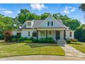 Charming home with manicured lawn and inviting front porch, providing curb appeal and a warm welcome at 125 Lord Ashley Rd, Raleigh, NC 27610