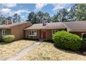 Charming single-story home with a red front door, well-maintained landscaping, and a cozy curb appeal at 139 Hollyhock Ct, Durham, NC 27713