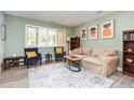 Bright living room with modern decor, large window, comfortable seating, and stylish accents creating a welcoming space at 139 Hollyhock Ct, Durham, NC 27713
