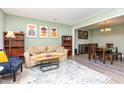 Bright living room with modern decor, comfortable seating, open to dining area, enhancing the inviting atmosphere at 139 Hollyhock Ct, Durham, NC 27713