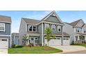 Charming home showcasing a manicured lawn, modern facade, and inviting entrance for lasting impressions at 140 Summer Mist Ln # 159, Clayton, NC 27527