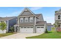 Beautiful two-story home highlighting the spacious 3-car garage and landscaped front yard at 140 Summer Mist Ln # 159, Clayton, NC 27527