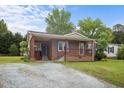 Charming one-story brick home with a cozy front porch and well-maintained lawn at 1416 Chestnut St, Roxboro, NC 27573