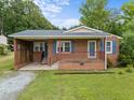 Charming one-story brick home with a cozy front porch and well-maintained lawn at 1416 Chestnut St, Roxboro, NC 27573