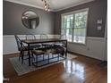 Beautiful dining room featuring a statement mirror, stylish light fixture, and refinished hardwood flooring at 154 Hillsdale Dr, Archer Lodge, NC 27527