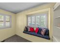 Comfortable window seat with patterned pillows and white shutters, complemented by built-in shelves at 205 W Oak Ave, Wake Forest, NC 27587