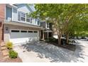 Charming townhome with brick and siding, featuring a two-car garage and beautifully landscaped front yard at 2082 Weston Green Loop Loop, Cary, NC 27513