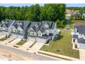 An aerial view captures the appealing townhome with manicured lawn and a glimpse of the surrounding community at 228 Shingle Oak Rd, Wake Forest, NC 27587