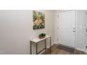 Bright foyer features a marble-topped console table, floral art, and an inviting entrance with wood-look floors at 228 Shingle Oak Rd, Wake Forest, NC 27587