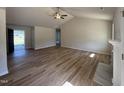 Spacious living room with hardwood floors, vaulted ceilings, fan, and abundant natural light at 240 Eason Creek Way, Clayton, NC 27527