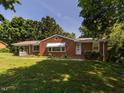 Charming single-story brick home with a well-manicured lawn and mature trees at 2434 Morningside Dr, Burlington, NC 27217