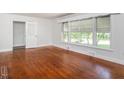 Spacious living room featuring hardwood floors, large windows, and neutral paint colors at 2434 Morningside Dr, Burlington, NC 27217
