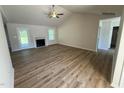 Spacious living room with high ceilings, fireplace, ceiling fan, and sliding glass door to the backyard at 245 Eason Creek Way, Clayton, NC 27527