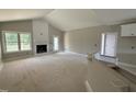 Spacious living room with vaulted ceiling and a cozy fireplace at 2760 Rains Mill Rd, Princeton, NC 27569