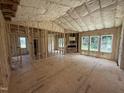 Large open-concept living room featuring wood-frame construction, insulation, and window views at 2776 Rains Mill Rd, Princeton, NC 27569