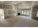 Bright living room featuring a fireplace and access to the outdoor area via a glass door at 2776 Rains Mill Rd, Princeton, NC 27569