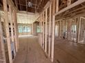 Open-concept living room with wood-frame construction, insulation, and views to exterior at 2776 Rains Mill Rd, Princeton, NC 27569